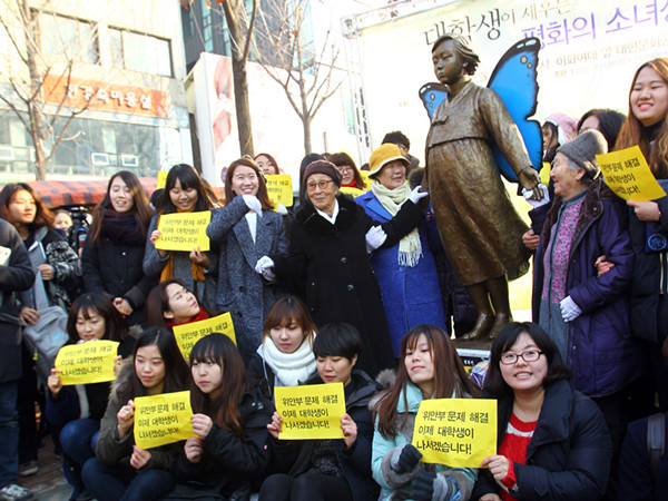 圖為2014年12月24日，在韓國(guó)首都首爾，由韓國(guó)大學(xué)生捐資設(shè)立的新“慰安婦”少女像在首爾市梨花女子大學(xué)附近的一座公園內(nèi)舉行揭幕儀式。
