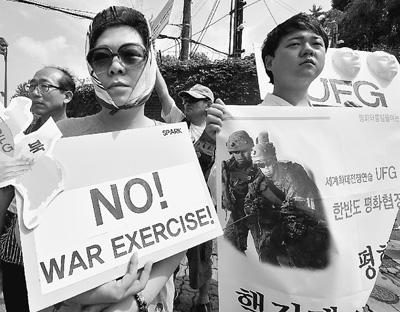 8月19日，在位于韓國(guó)首都首爾的一個(gè)美軍軍事基地外，韓國(guó)反戰(zhàn)人士手舉布告，抗議韓美聯(lián)合軍事演習(xí)。